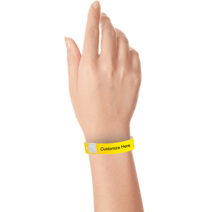hand wearing plastic regular 3/4" wristband with a placeholder to show where you can customize the wristband in pantone yellow