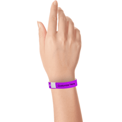 hand wearing plastic regular 3/4" wristband with a placeholder to show where you can customize the wristband in purple 