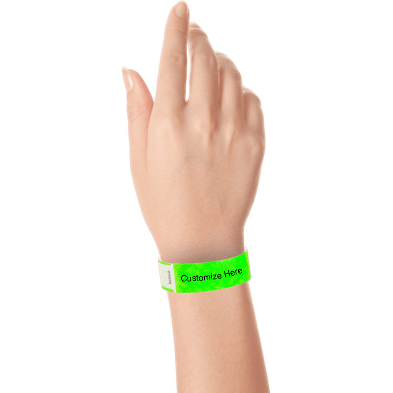 hand wearing tyvek 3/4" solid qwik fit wristband showing a placeholder for customization in neon green