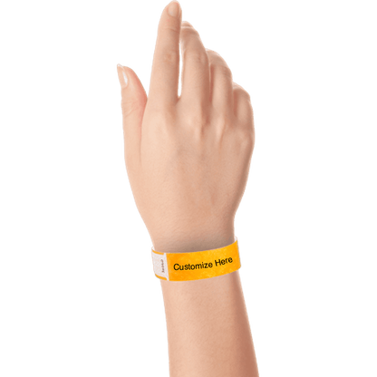 hand wearing tyvek 3/4" solid qwik fit wristband showing a placeholder for customization in neon orange