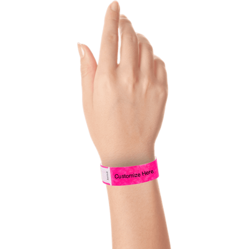 hand wearing tyvek 3/4" solid qwik fit wristband showing a placeholder for customization in neon pink