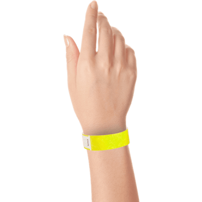 hand wearing tyvek 3/4" solid qwik fit wristband in neon yellow