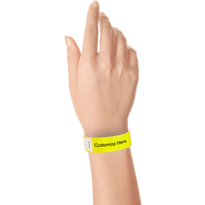 hand wearing tyvek 3/4" solid qwik fit wristband showing a placeholder for customization in neon yellow