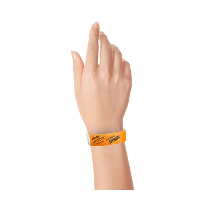 hand wearing neon orange tyvek wristband with saturday text in black ink repeated