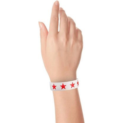 Hand wearing a white tyvek wristband with neon red stars 