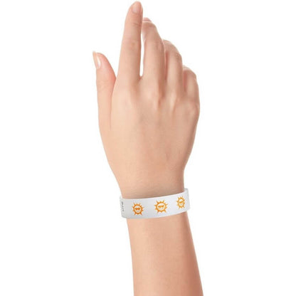 hand wearing white tyvek wristband with neon orange sun pattern repeated