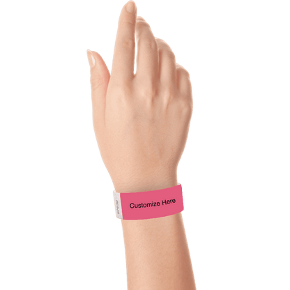 hand wearing a cranberry tyvek 1" solid wristband with a placeholder to customize with your text or logo