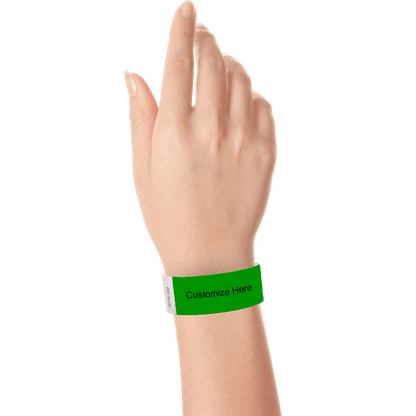 hand wearing a kelly green tyvek 1" solid wristband with a placeholder to customize with your text or logo
