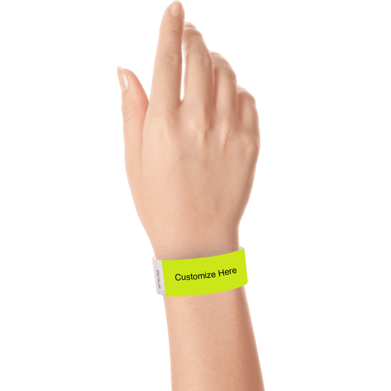 hand wearing a lime green tyvek 1" solid wristband with a placeholder to customize with your text or logo