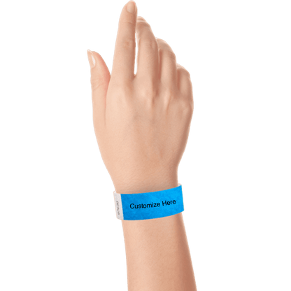 hand wearing a neon blue tyvek 1" solid wristband with a placeholder to customize with your text or logo