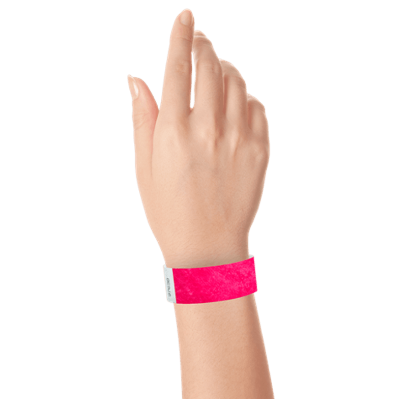 neon pink tyvek 1" solid wristband on hand