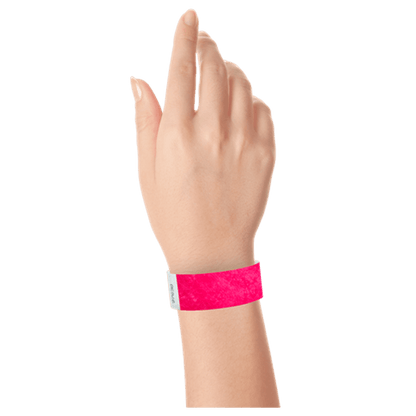 neon pink tyvek 1" solid wristband on hand