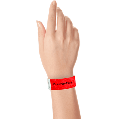 hand wearing a neon red tyvek 1" solid wristband with a placeholder to customize with your text or logo