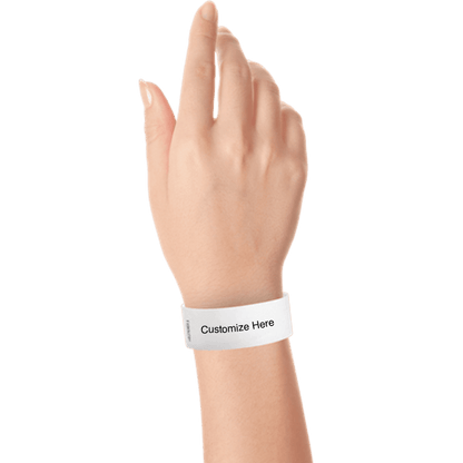 hand wearing a white tyvek 1" solid wristband with a placeholder to customize with your text or logo