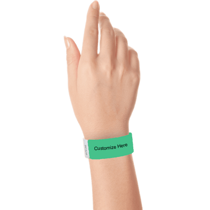 hand wearing a pantone green tyvek 1" solid wristband with a placeholder to customize with your text or logo 