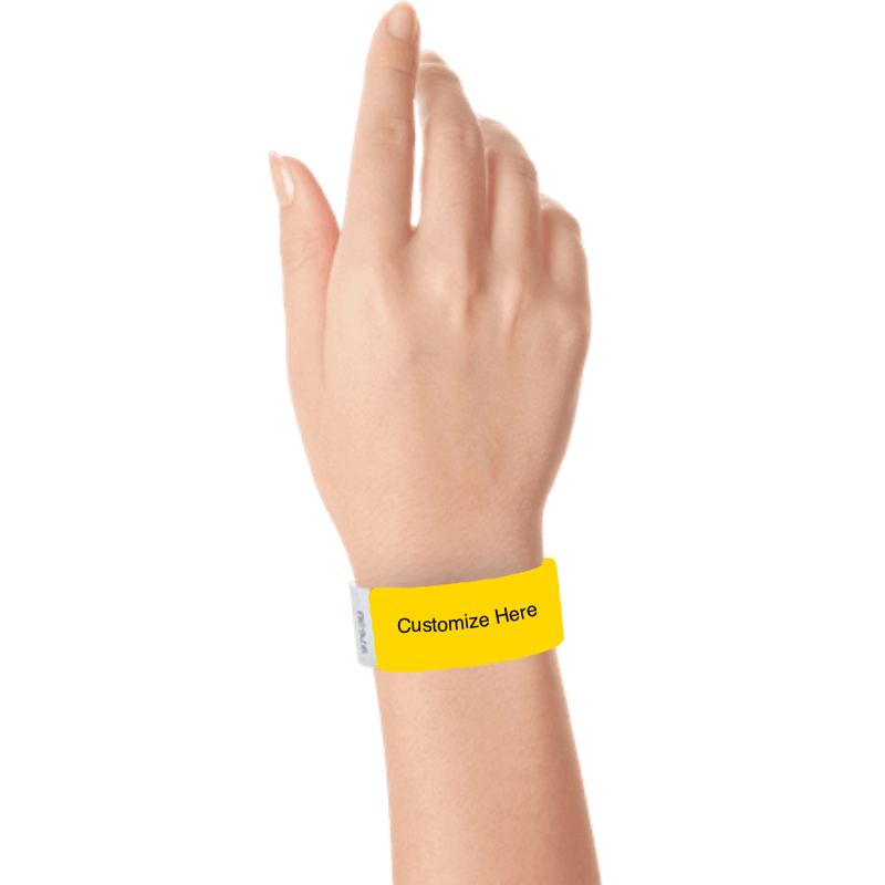 hand wearing a pantone yellow tyvek 1" solid wristband with a placeholder to customize with your text or logo 