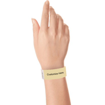 hand wearing a gold tyvek 1" solid wristband with a placeholder to customize with your text or logo 