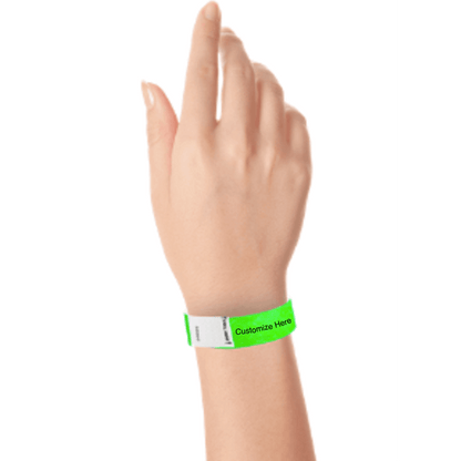 hand wearing a neon green tyvek 3/4" litter free wristband with a placeholder for customizing with your text or logo