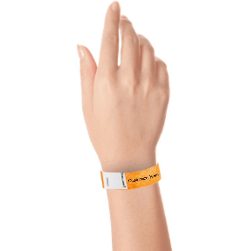 hand wearing a neon orange tyvek 3/4" litter free wristband with a placeholder for customizing with your text or logo