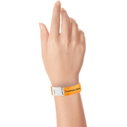 hand wearing a neon orange tyvek 3/4" litter free wristband with a placeholder for customizing with your text or logo