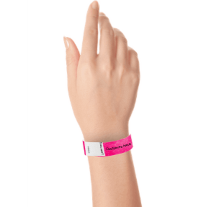 hand wearing a neon pink tyvek 3/4" litter free wristband with a placeholder for customizing with your text or logo