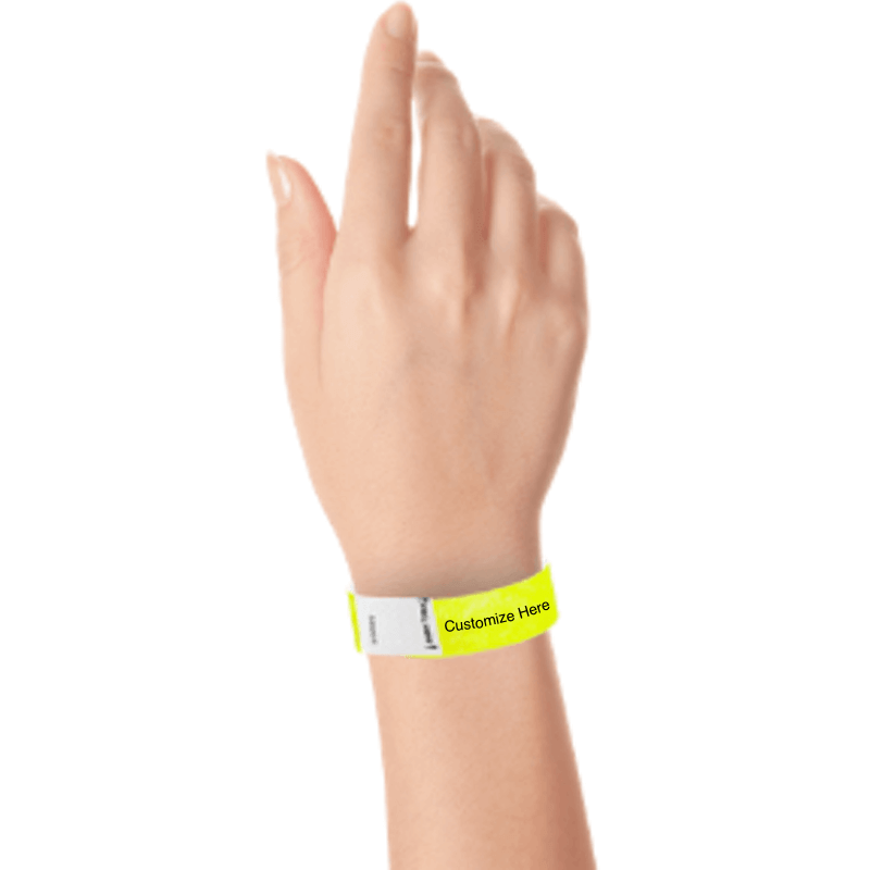hand wearing a neon yellow tyvek 3/4" litter free wristband with a placeholder for customizing with your text or logo