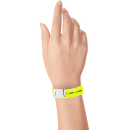 hand wearing a neon yellow tyvek 3/4" litter free wristband with a placeholder for customizing with your text or logo