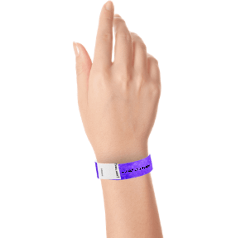 hand wearing a purple tyvek 3/4" litter free wristband with a placeholder for customizing with your text or logo