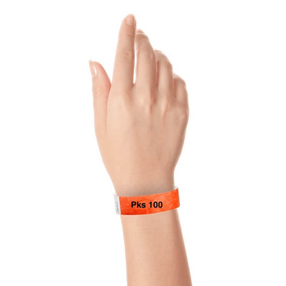 a hand wearing tyvek 3/4" solid wristband coral red pks 100