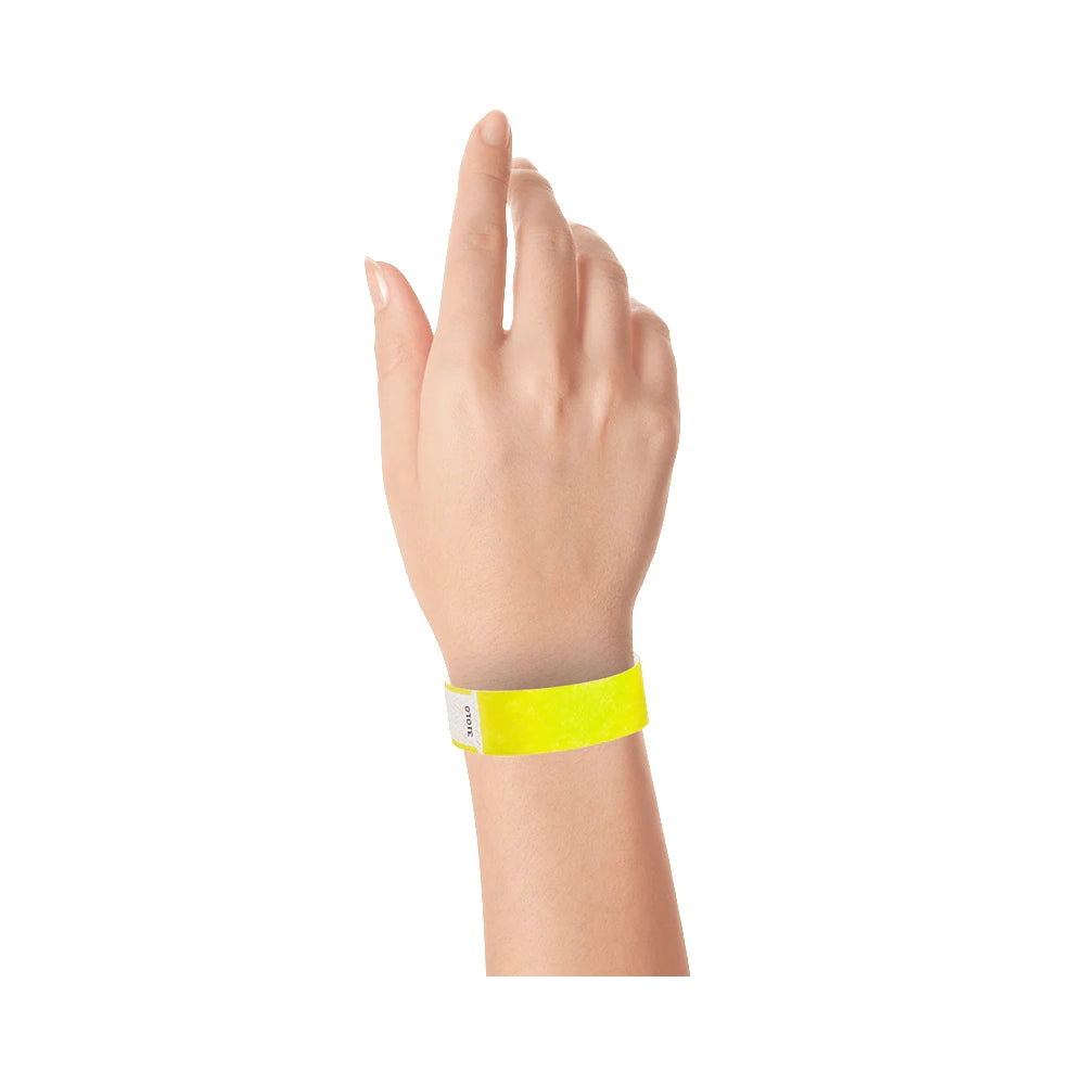 Wrist wearing solid neon yellow qwik fit tyvek 3-4 wristband