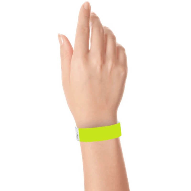 hand wearing a 3/4" tyvek wristband solid lime green