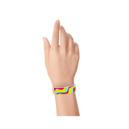 tyvek 3/4" wristband with neon red, neon yellow and aqua groovy stripe pattern shown on hand 
