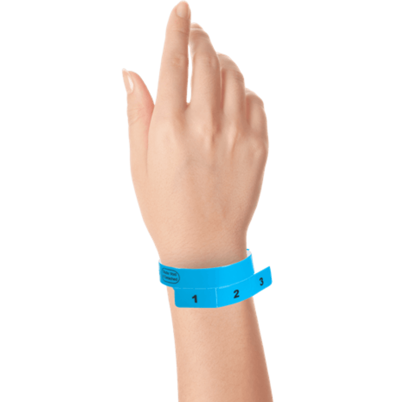 vinyl 3 tab wristbands shown in stock pattern with imprint "stub void if detached" and the number 1-3 on the stubs in navy blue on hand 