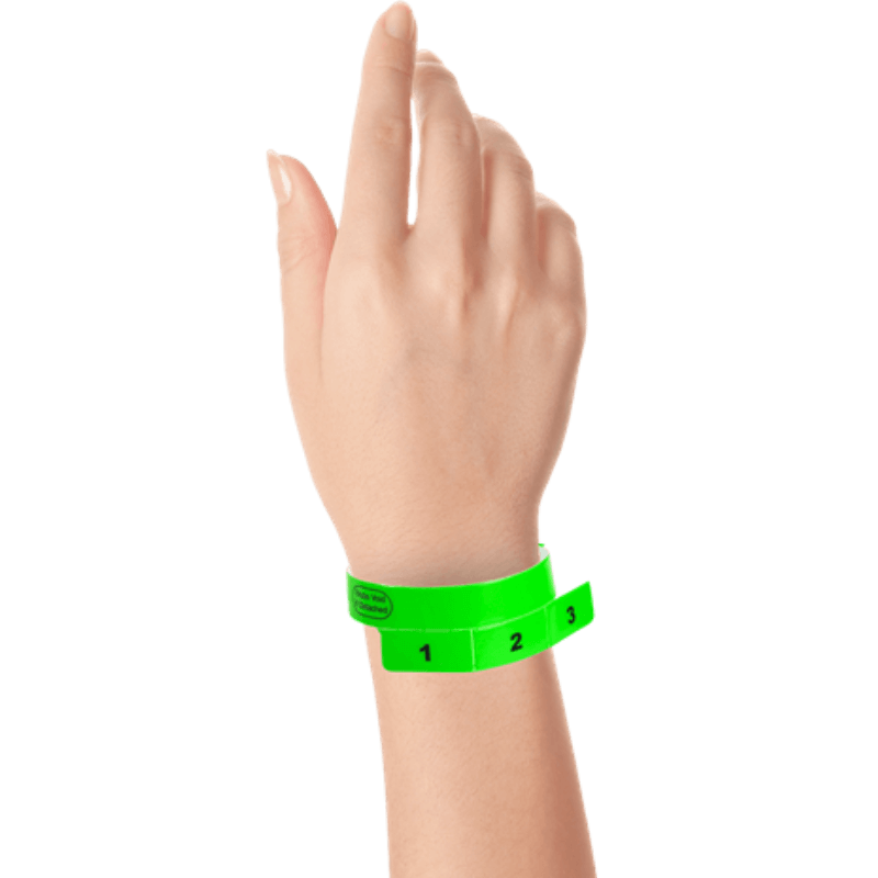 vinyl 3 tab wristbands shown in stock pattern with imprint "stub void if detached" and the number 1-3 on the stubs in neon green on hand 