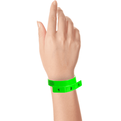 vinyl 3 tab wristbands shown in stock pattern with imprint "stub void if detached" and the number 1-3 on the stubs in neon green on hand 