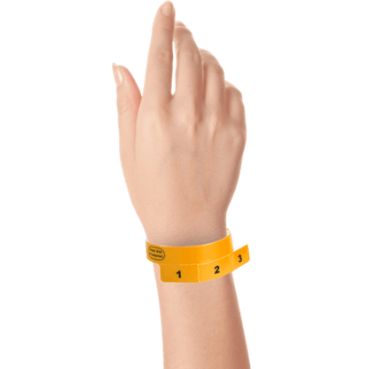 vinyl 3 tab wristbands shown in stock pattern with imprint "stub void if detached" and the number 1-3 on the stubs in neon orange on hand 