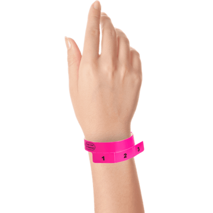 vinyl 3 tab wristbands shown in stock pattern with imprint "stub void if detached" and the number 1-3 on the stubs in neon pink on hand 