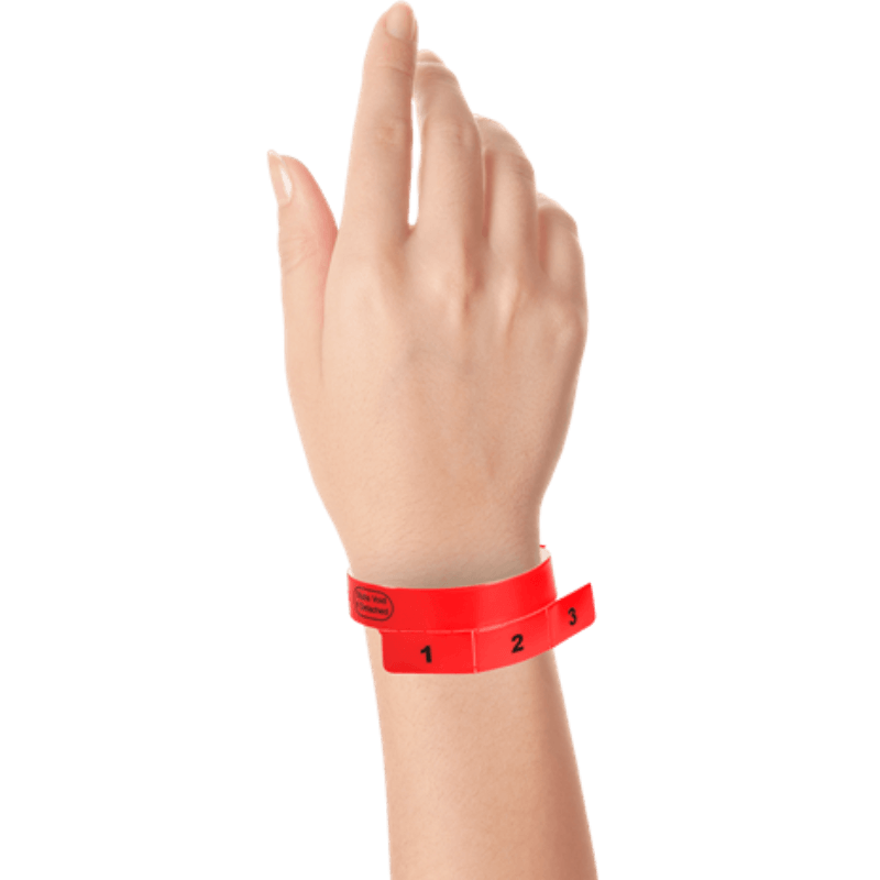 vinyl 3 tab wristbands shown in stock pattern with imprint "stub void if detached" and the number 1-3 on the stubs in neon red on hand 