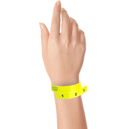vinyl 3 tab wristbands shown in stock pattern with imprint "stub void if detached" and the number 1-3 on the stubs in neon yellow on hand 