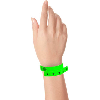 vinyl 5 tab wristbands shown in stock pattern with imprint "stub void if detached" and the number 1-5 on the stubs, shown on hand in neon green