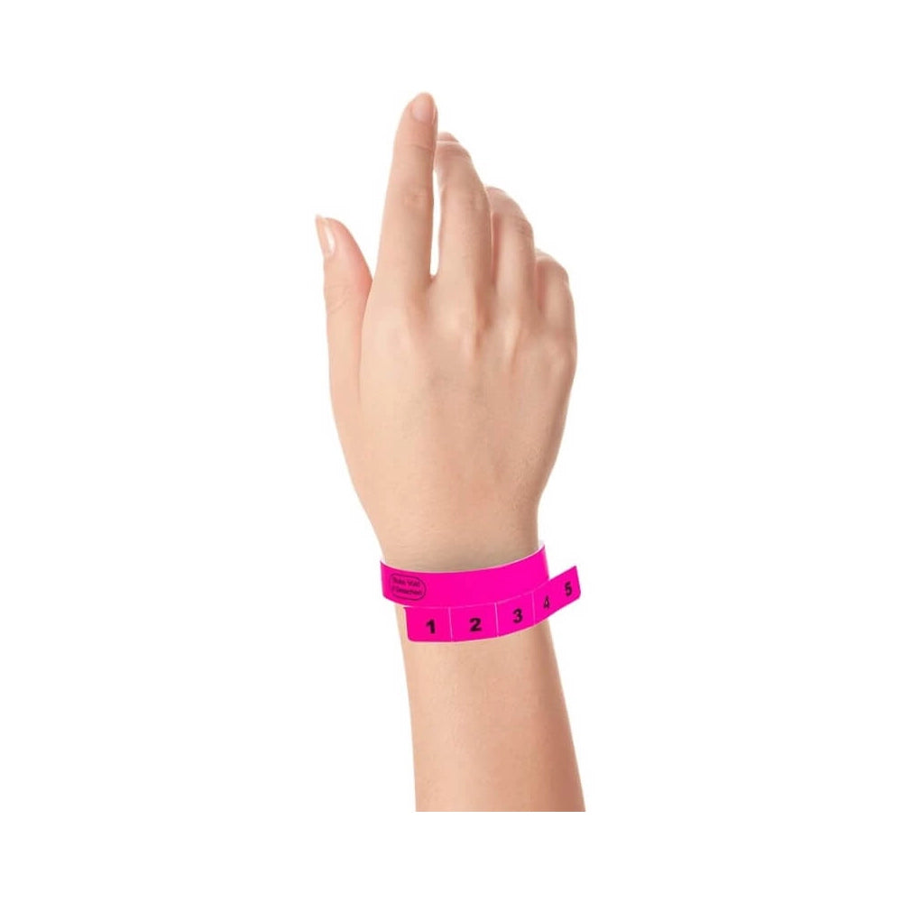 vinyl wristband with 5 tabs in neon pink - shown on wrist