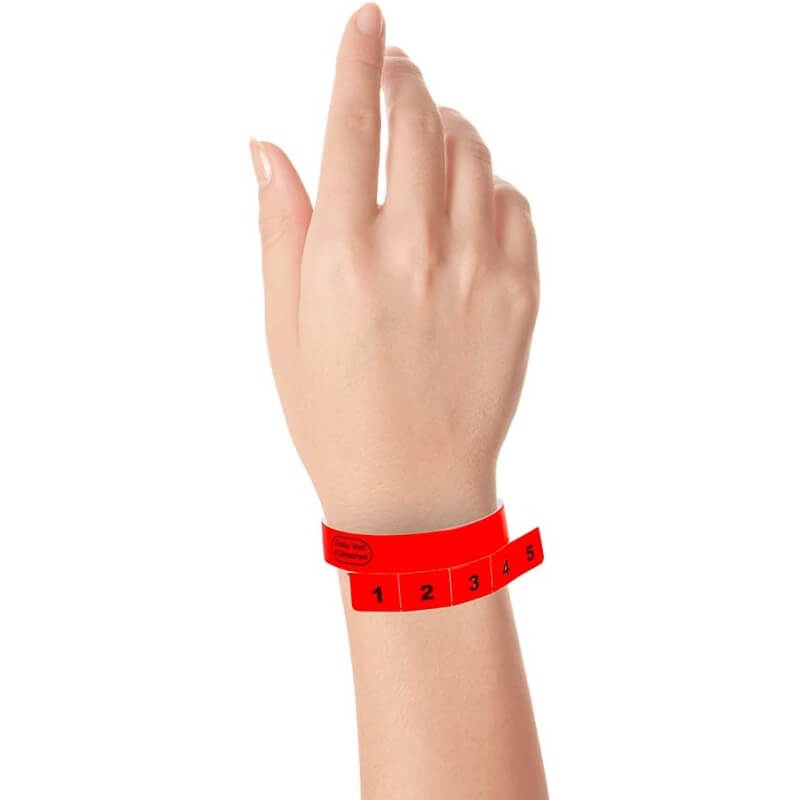 vinyl 5 tab wristbands shown in stock pattern with imprint "stub void if detached" and the number 1-5 on the stubs, shown on hand in neon red
