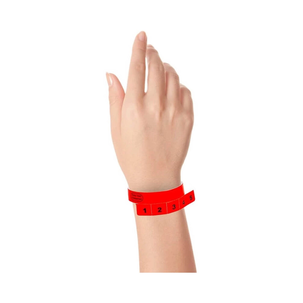 vinyl wristband with 5 tabs in neon red - shown on wrist