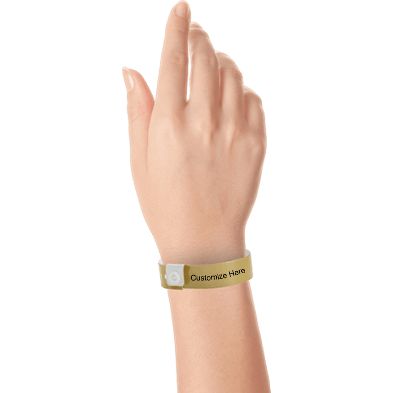 hand wearing regular vinyl wristbands with a placeholder to show where you can customize the wristband in gold