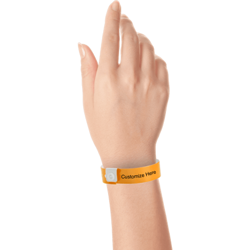 hand wearing regular vinyl wristbands with a placeholder to show where you can customize the wristband in neon orange