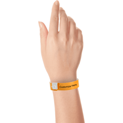 hand wearing regular vinyl wristbands with a placeholder to show where you can customize the wristband in neon orange