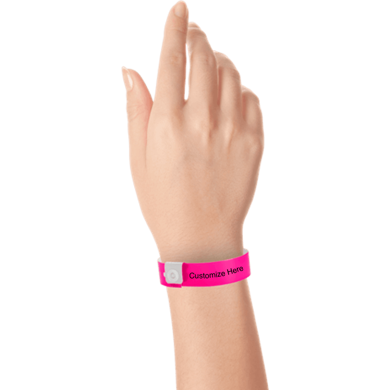 hand wearing regular vinyl wristbands with a placeholder to show where you can customize the wristband in neon pink