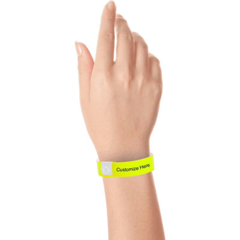 hand wearing regular vinyl wristbands with a placeholder to show where you can customize the wristband in neon yellow