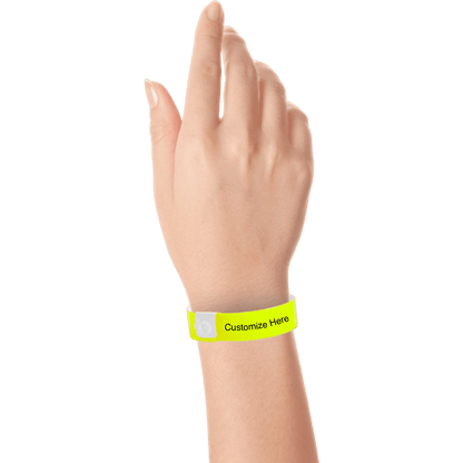 hand wearing regular vinyl wristbands with a placeholder to show where you can customize the wristband in neon yellow