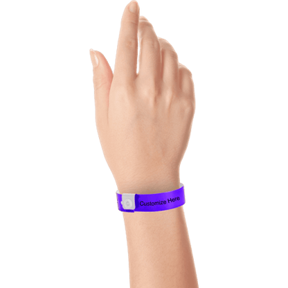 hand wearing regular vinyl wristbands with a placeholder to show where you can customize the wristband in purple